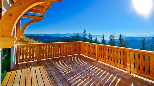 A wooden deck with a view of mountains and trees. - Das Almhaus in Bad St. Leonhard im Lavanttal by Interhome (Klippitztörl)