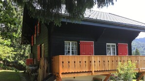 A wooden cabin with a balcony, surrounded by a garden and trees. - Maiensäss Romantica by Interhome (Châtel-Saint-Denis)
