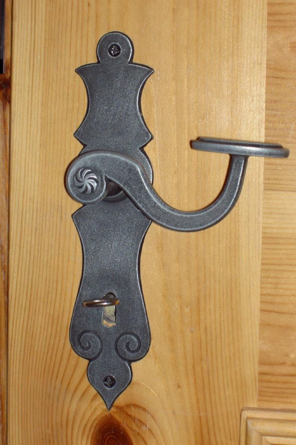 A wooden door with a metal door handle.