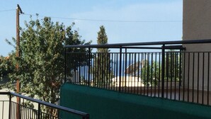 A balcony with a metal railing, a green awning, and a view of the sea. - MYHIDEAWAY APARTMENT mit kostenlosem WiFi by Interhome (Peyia)