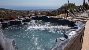 A hot tub with a view of the landscape, surrounded by lounge chairs and a railing. - Villa mit Blick auf die Berge und Whirlpool by Interhome (Kathikas Village)