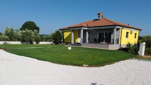 A two-story house with a red-tiled roof, a covered porch, and a well-maintained lawn. - mit Terrasse, Grill und Garten by Interhome (Umag/Juricani)