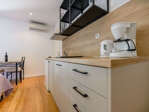 A compact kitchen with a wooden countertop, a coffee maker, and a wine bottle on the table. - Studio-Apartment "Nives" mit Blick auf das Wasser by Interhome (Zadar/Bibinje)