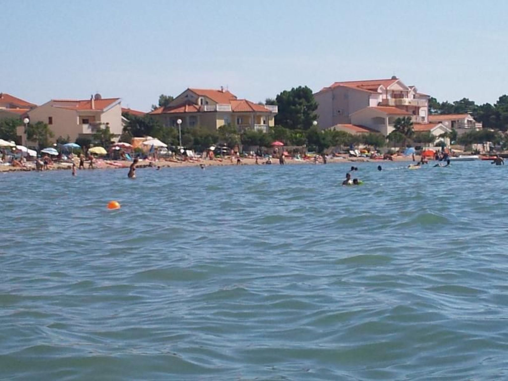 A beach with houses in the background.
