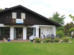 A two-story building with a balcony, a sign with a phone number, and a number '182/1' on the wall. - Haus Aschenputtel by Interhome (Frielendorf)