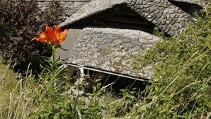 A traditional stone-roofed building with a small attached structure. - Casa Lina by Interhome (Bondo)