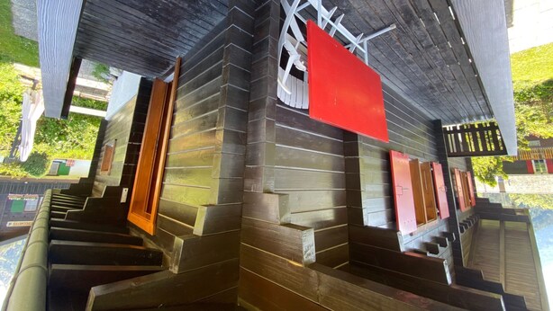 A modern building with a wooden exterior and a red sign. - Chalet Oase by Interhome (Leuk-Susten)