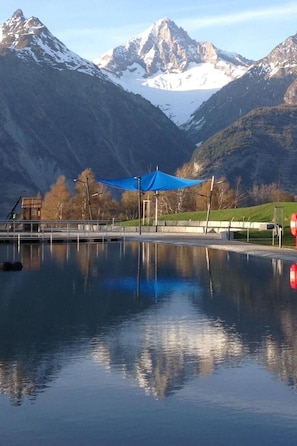A calm lake with a blue canopy and a mountain backdrop. - in Unterbäch by Interhome (Unterbäch)