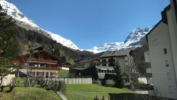 A mountain resort with wooden cabins and modern buildings, surrounded by snow-capped mountains. - Siesta 3,5-Zimmer-Wohnung by Interhome (Leukerbad)