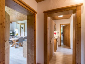 A wooden interior hallway with a dining area visible through an open door. - Appartement "Hochgefühl" by Interhome (Leutasch)