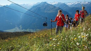 A group of people hiking with a cable car in the background. - Bio-Haus # 402 by Interhome (Neukirchen am Großvenediger)