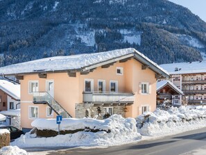 A hotel with a stone facade, a balcony, and a sign that reads "Hotel". - Eck-Haus Nr. 900 by Interhome (Neukirchen am Großvenediger)