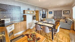 A modern kitchen with a dining area, a sofa, and a TV. - Wohnung mit Meerblick, 200m vom Strand entfernt by Interhome (Novi Vinodolski)