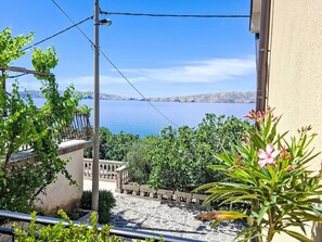 A balcony with a view of a body of water and distant hills. - Gesamte Wohnung mit Terrasse und Meerblick by Interhome (Senj)