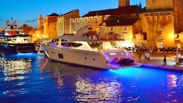 A large yacht docked at a marina with a historic building in the background. - Carpe Diem by Interhome (Trogir)