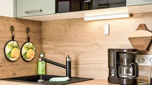 A kitchen with a modern design, featuring a sink, a coffee maker, and a wooden countertop. - Siebers by Interhome (Altendorf)