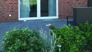 A brick building with a large arched glass door and a small window above it.