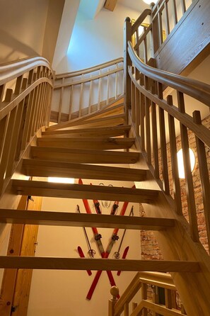 A wooden staircase with a handrail and a wall-mounted ski rack. - Fasa Lodge by Interhome (Oberwiesenthal)