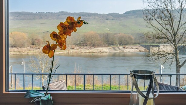 A view from a window with a river, a bridge, and hills in the background. - mit Balkon und schönem Moselblick by Interhome (Klüsserath)