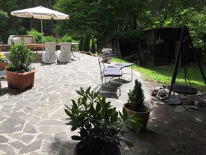 A patio area with stone flooring, outdoor furniture, and potted plants. - Fachwerkhaus mit Garten, Grill und Terrasse by Interhome (Blankenheim)