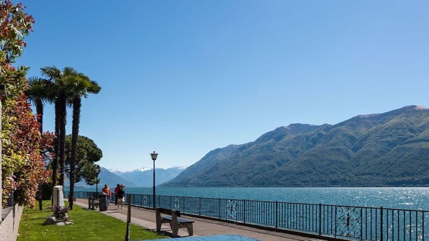 A swimming pool with a view of a lake and mountains. - Haus Antonini by Interhome (Brissago)