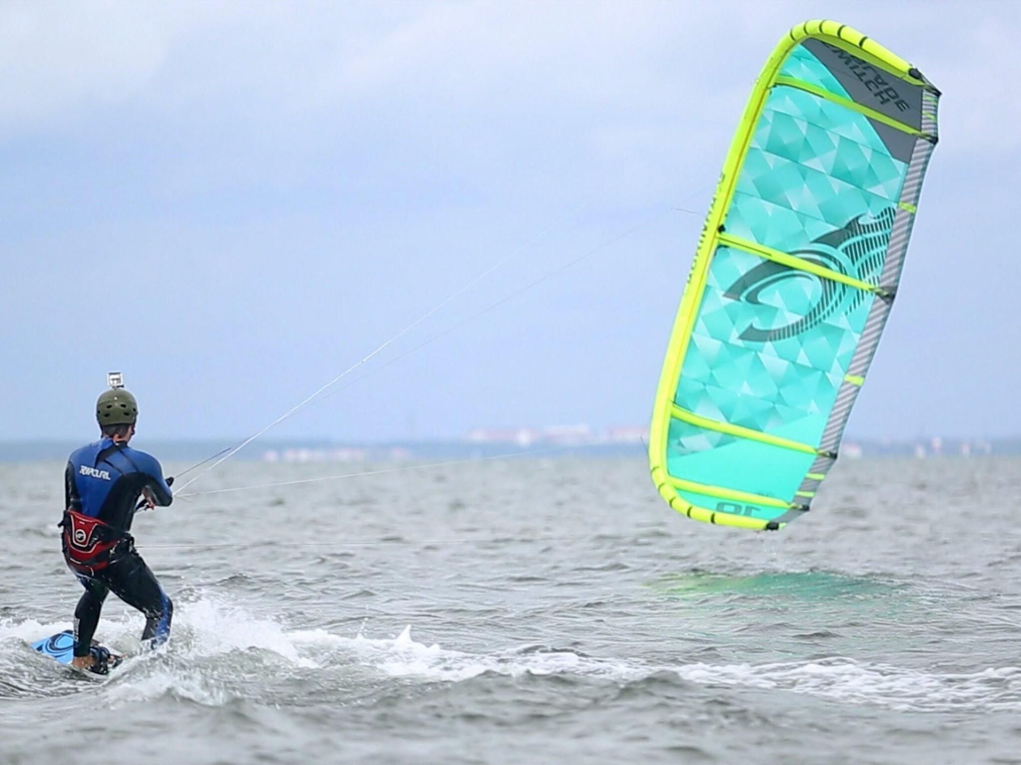 A person windsurfing on a body of water.