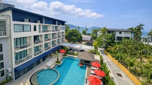 A hotel with a swimming pool, multiple balconies, and a view of the sea. - Aqua Maya Phuket (Patong)