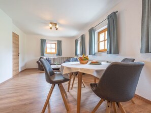 A dining area with a round table, chairs, and a bowl of fruit. - mit Terrasse und zwei Schlafzimmer by Interhome (Breitenberg)