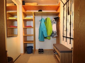 A compact storage area with wooden shelves, a blue bucket, and a bench. - Apartment Igel by Interhome (Bad Bayersoien)