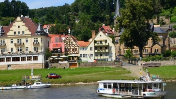 Ein Fluss mit einem Boot und Gebäuden an den Ufern.