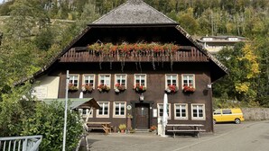 A traditional chalet with a sloped roof, wooden exterior, and flower boxes on the windows. - Apartment Ebser by Interhome (Todtnau)