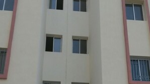A multi-story building with a central entrance, multiple windows, and a red and white color scheme. - Résidence Mogador 1 by Interhome (Agadir)