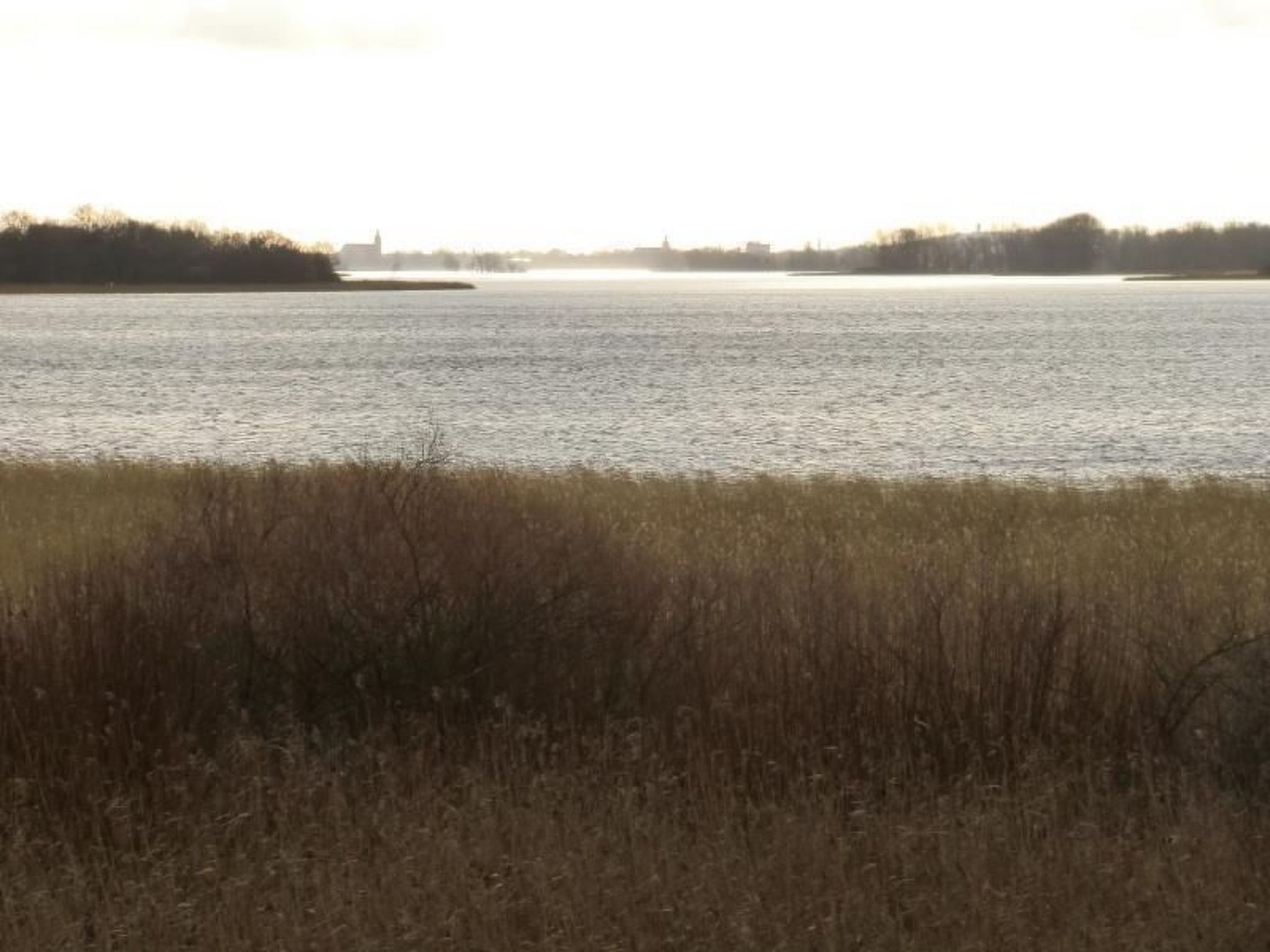 A wide river with a distant building on the far bank.