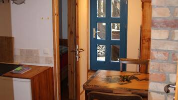 Eine Küche mit Holzausstattung, einem Spülbecken und einem Essbereich mit Tisch und Stühlen.