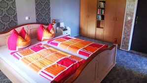 A bedroom with a bed, pillows, a nightstand, a wardrobe, and a bookshelf. - Appartement in Lütow mit Grill by Interhome (Krummin)