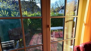 A room with a sliding glass door leading to a patio area. - Haus Strandhafer by Interhome (Baabe)