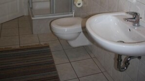 A bathroom with a shower, toilet, and sink. - in Strandnähe in Ahlbeck by Interhome (Ahlbeck)