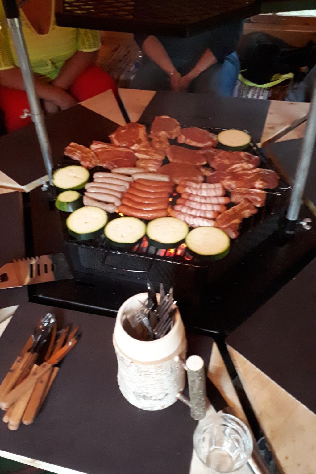 A grill with various meats and vegetables.