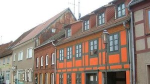 A street view with traditional half-timbered buildings, a clear sky, and a paved road. - Uferpromenade 1 EG by Interhome (Waren)