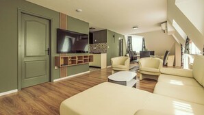 A modern living room with a flat-screen TV, a sofa, and a coffee table. - Caesar Apartment mit Terrasse, nahe dem Balaton by Interhome (Siofok)