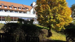 A building with a large glass facade, multiple windows, and a sloped roof. - mit Gemeinschaftspool und Terrasse by Interhome (Bad Waltersdorf)