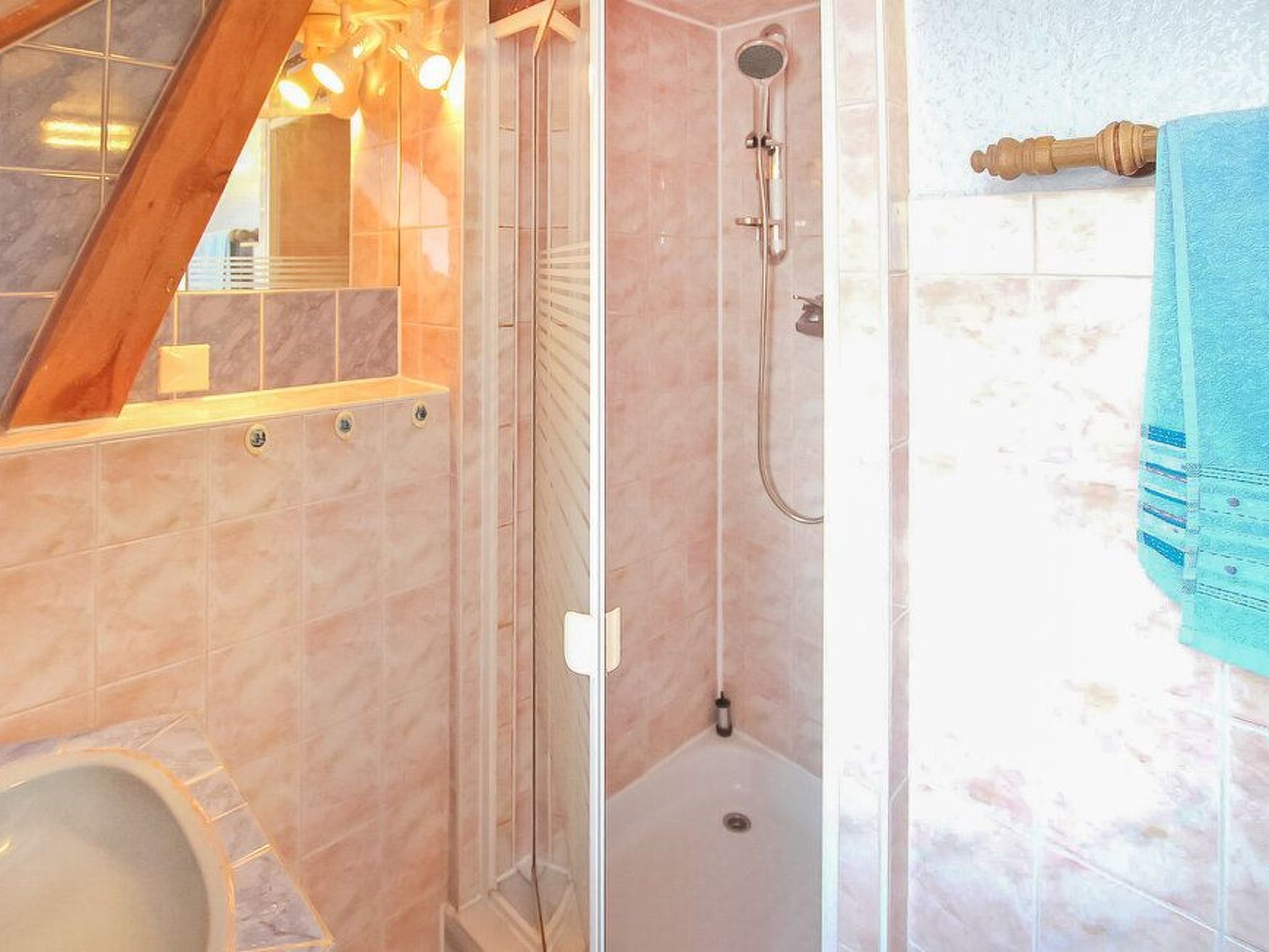 A bathroom with a shower, a toilet, and a bathtub.
