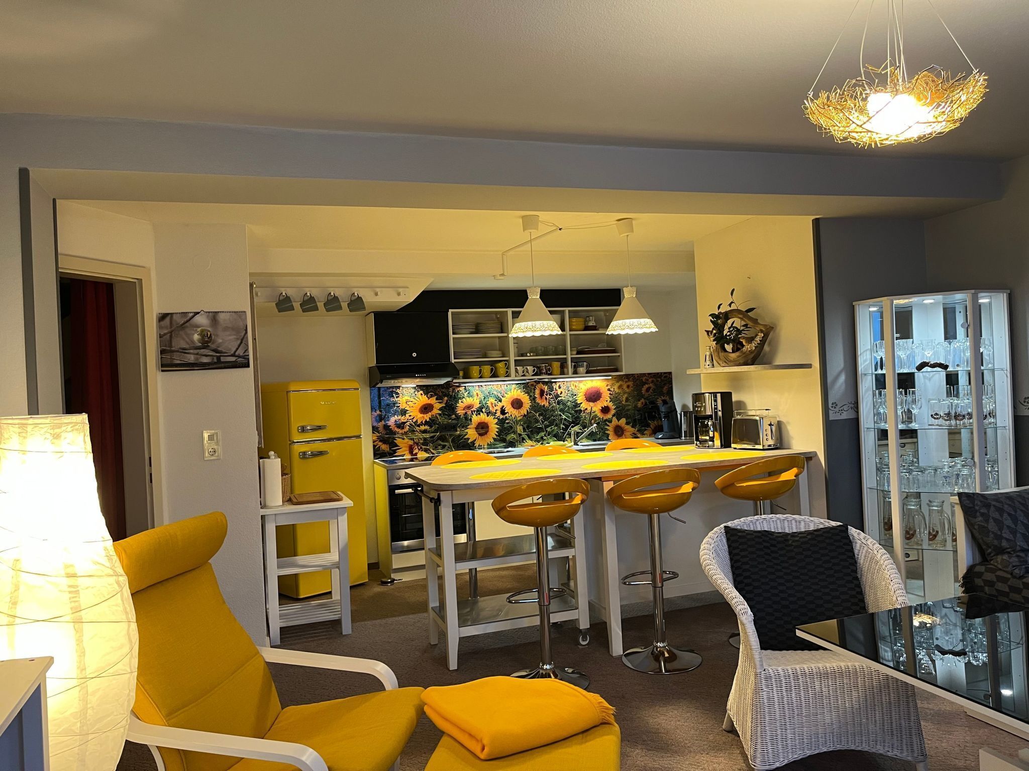 A compact living space with a kitchen, dining area, and seating area.
