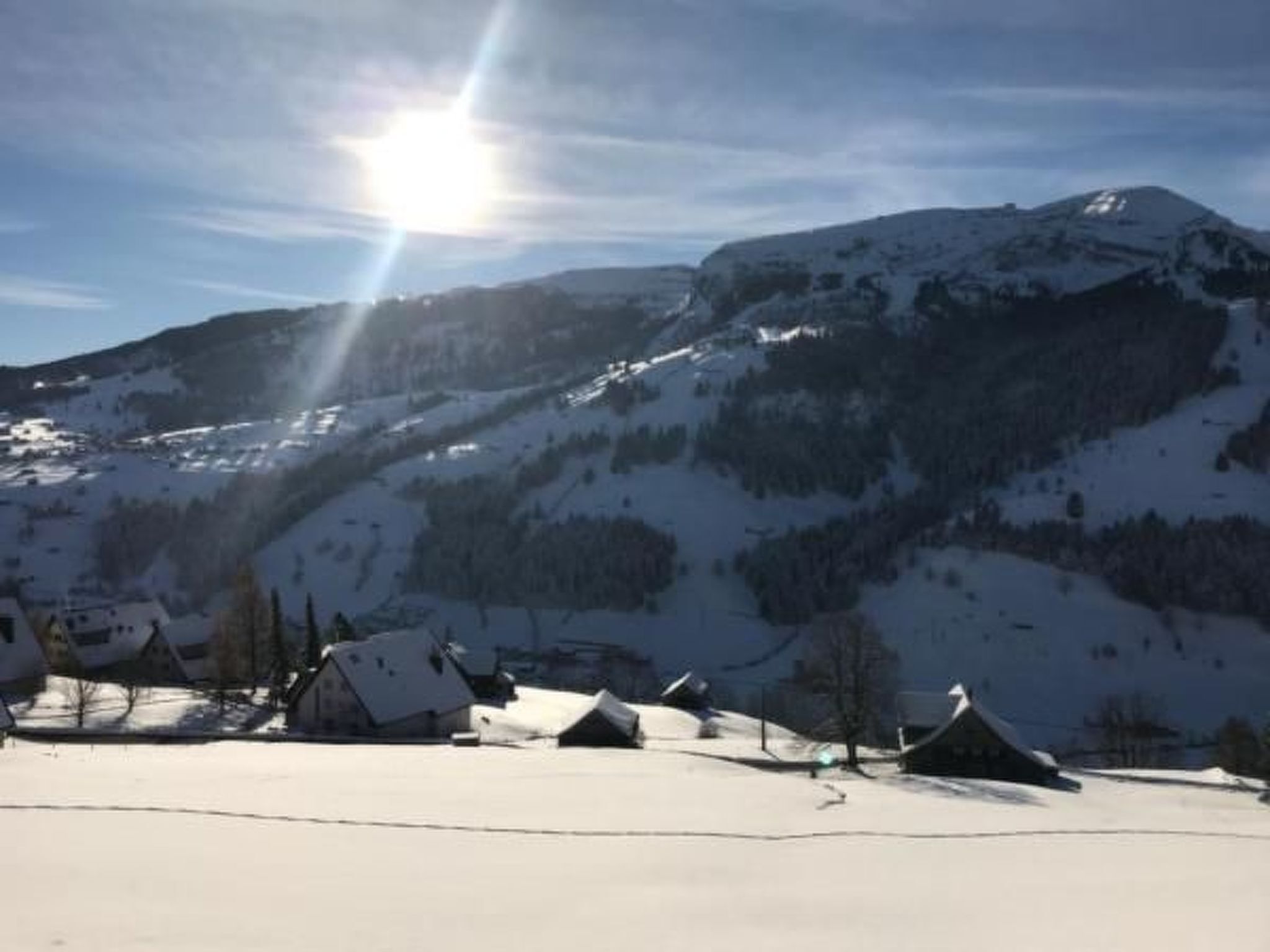 A snow-covered mountain landscape with a clear sky.