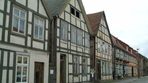 A row of traditional half-timbered buildings with a cobblestone street. - mit Garten, Terrasse und Grill by Interhome (Plau am See)