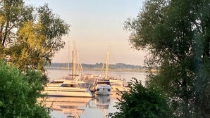 A marina with boats docked, surrounded by trees and a calm body of water. - mit Terrasse in Sellin by Interhome (Ostseebad Sellin)