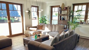 A modern living room with a sectional sofa, a coffee table, and a bookshelf. - mit Terrasse in Sellin by Interhome (Ostseebad Sellin)
