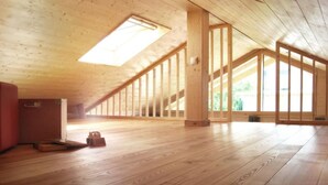 A spacious attic room with wooden floors, large windows, and a skylight. - "Gartenglück" by Interhome (Alt Jassewitz)