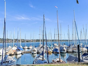 A marina with multiple sailboats docked, calm water, and a clear sky. - Wohlfühloase by Interhome (Steckborn)