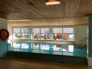 A pool area with a view of the beach, wooden ceiling, and a lifebuoy on the wall. - Wohnung mit herrlichem Blick auf den Pilatus by Interhome (Weggis)